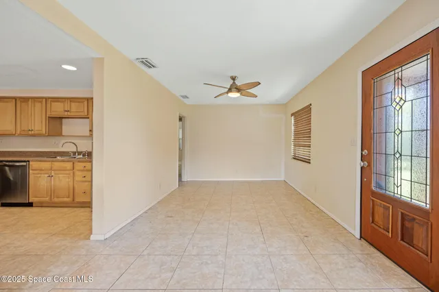 a view of a kitchen with furniture and an empty room