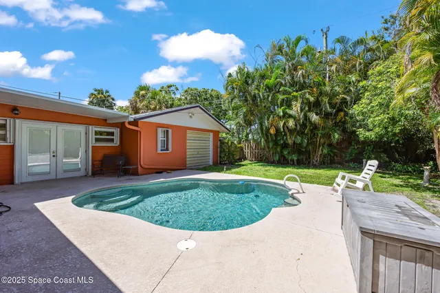 a view of a house with backyard porch and furniture