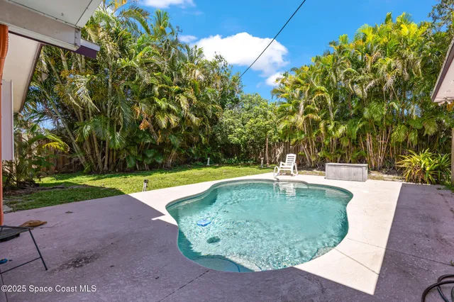 a view of a swimming pool with a patio