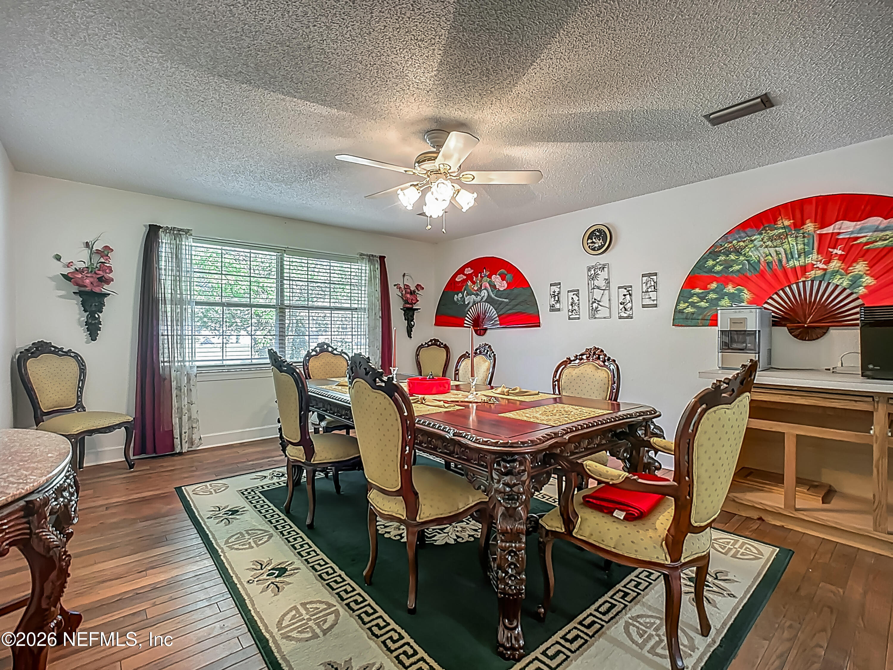 26504 Sheared Stokes Road Hilliard, FL 32046 - Photo 20 of 62 a view of a dining room with furniture and a chandelier