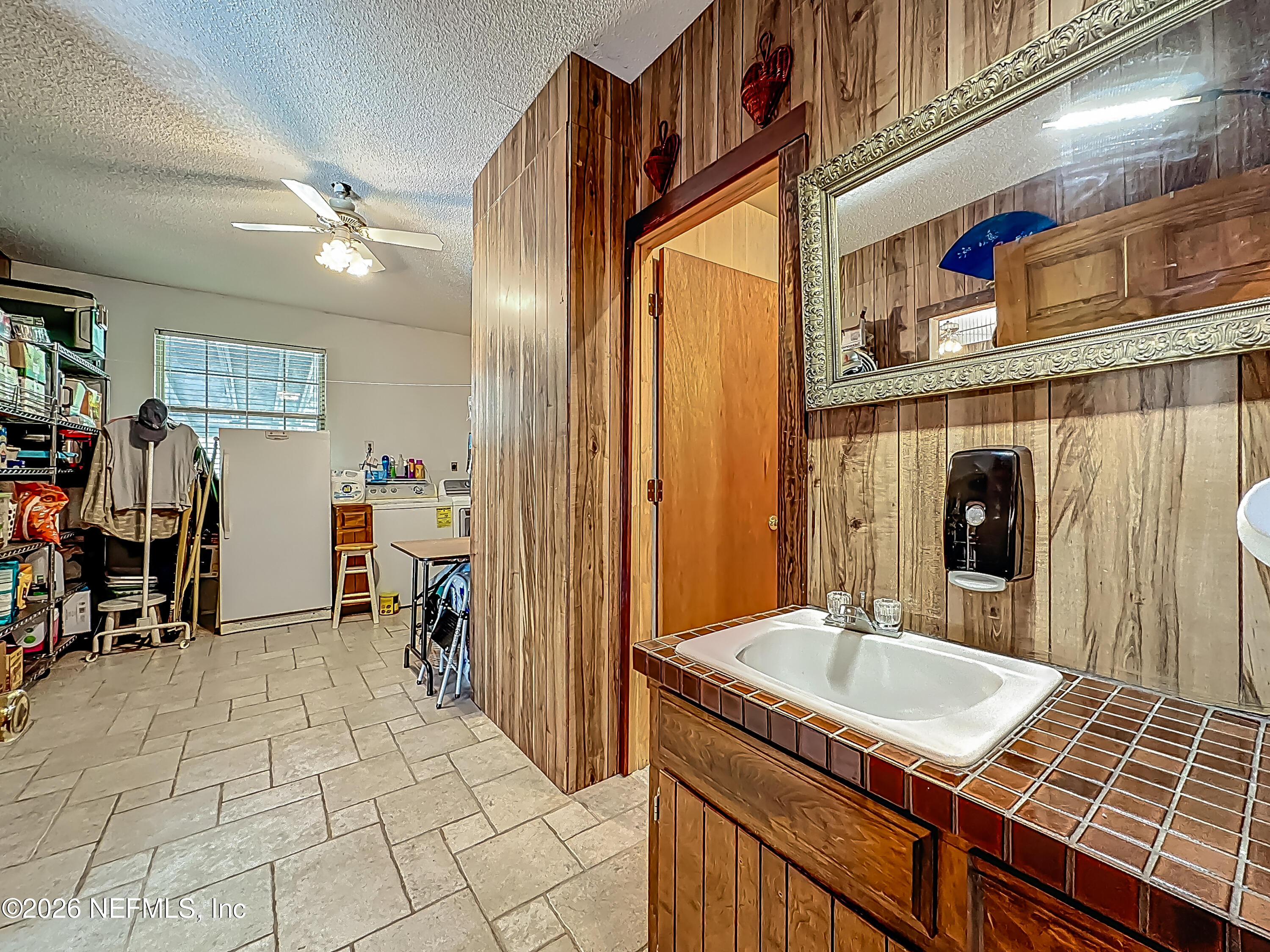 26504 Sheared Stokes Road Hilliard, FL 32046 - Photo 22 of 62 a bathroom with a sink and a mirror