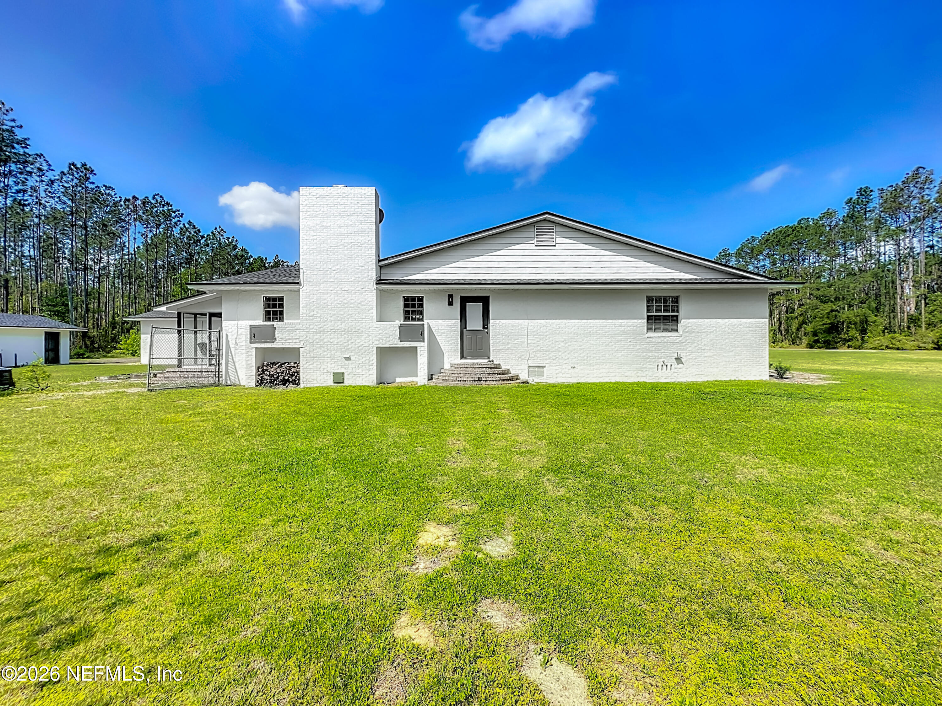 26504 Sheared Stokes Road Hilliard, FL 32046 - Photo 48 of 62 a front view of house with yard and green space
