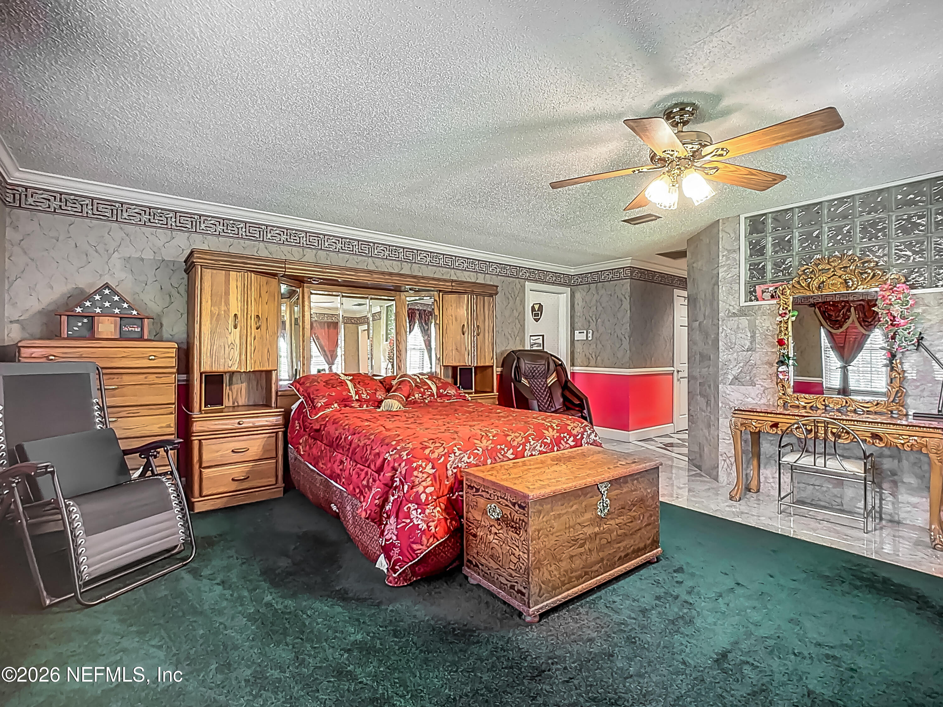 26504 Sheared Stokes Road Hilliard, FL 32046 - Photo 49 of 62 a bedroom with a bed and a chandelier