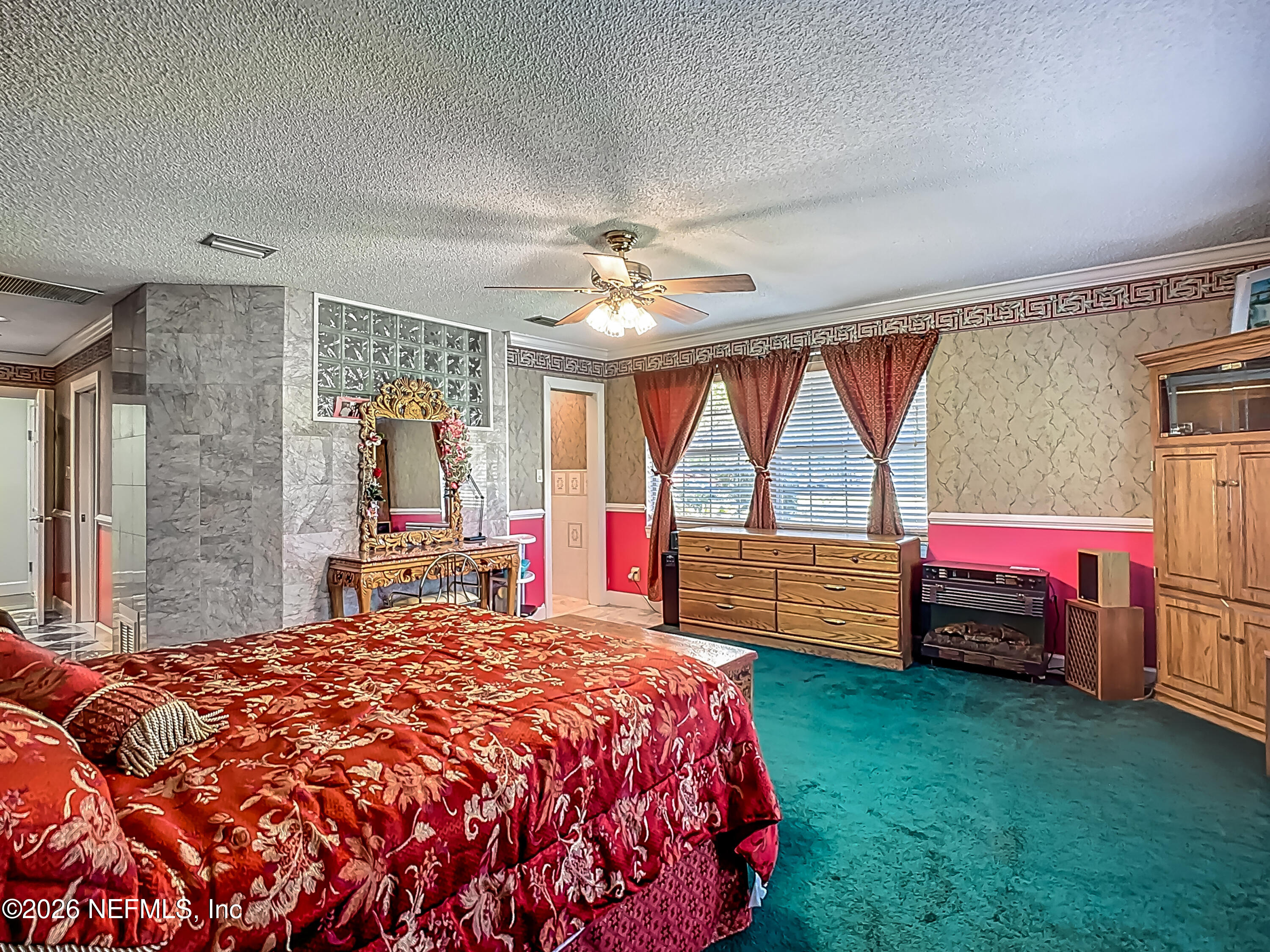 26504 Sheared Stokes Road Hilliard, FL 32046 - Photo 51 of 62 a bed sitting in a bedroom next to a window