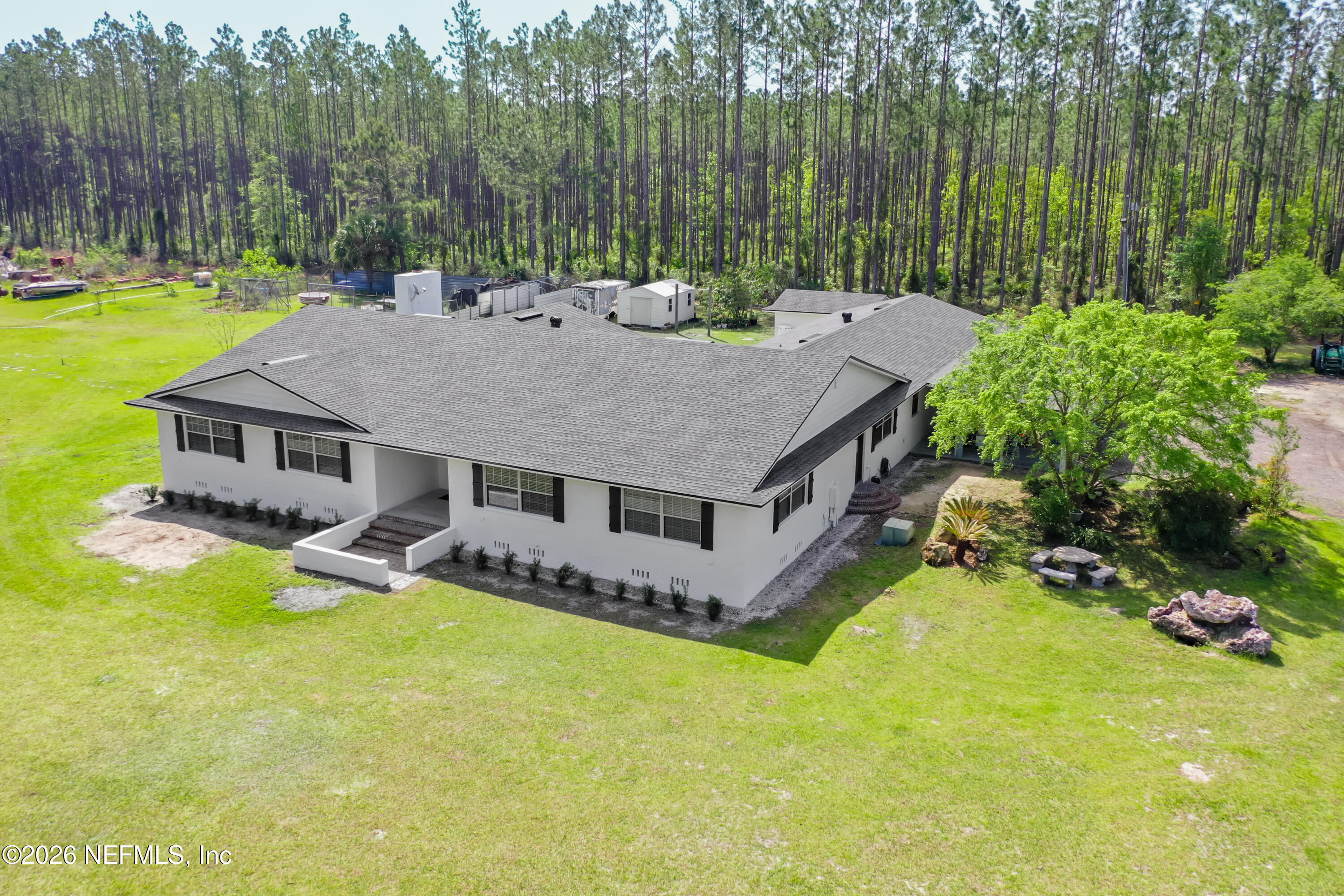 26504 Sheared Stokes Road Hilliard, FL 32046 - Photo 7 of 62 a aerial view of a house with swimming pool and a yard