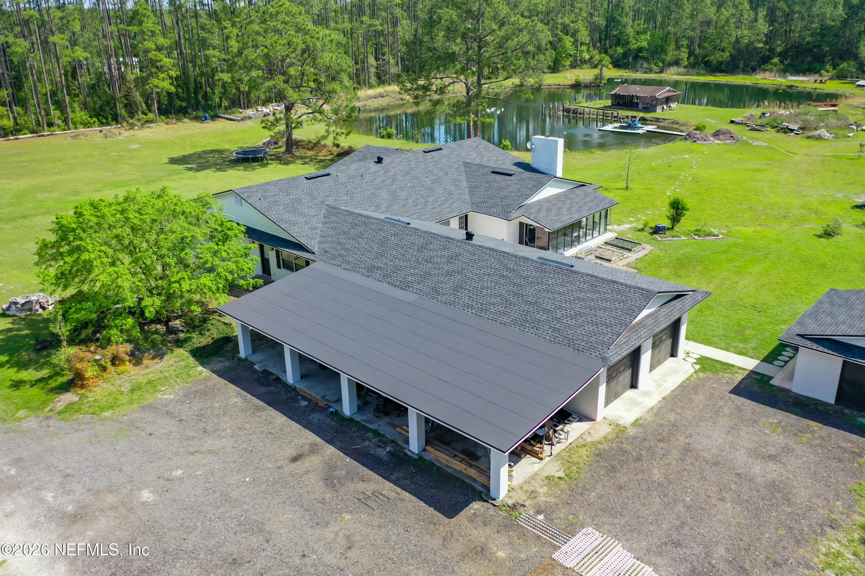 26504 Sheared Stokes Road Hilliard, FL 32046 - Photo 10 of 62 an aerial view of a house with swimming pool garden and patio