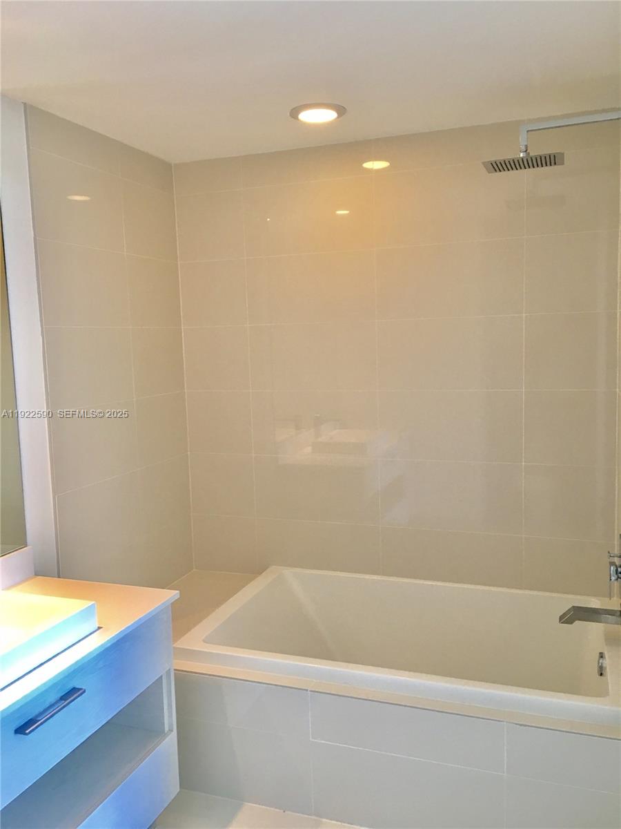 55 Southwest 9th Street, Unit 4005 Miami, FL 33130 - Photo 7 of 9 a bathroom with a bathtub and a shower