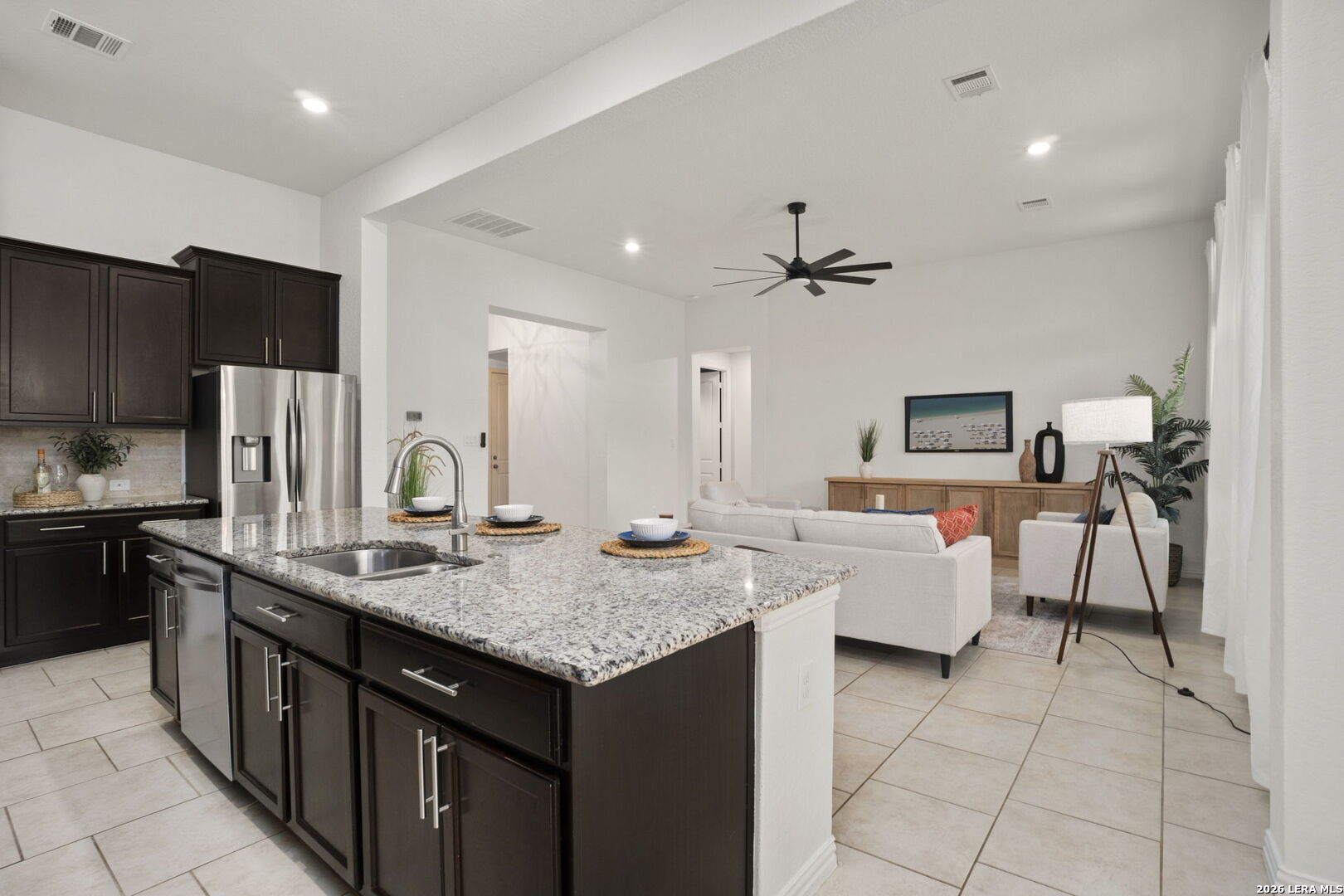 32134 Mirasol Bend Bulverde, TX 78163 - Photo 11 of 44 a kitchen with kitchen island granite countertop a sink refrigerator and cabinets
