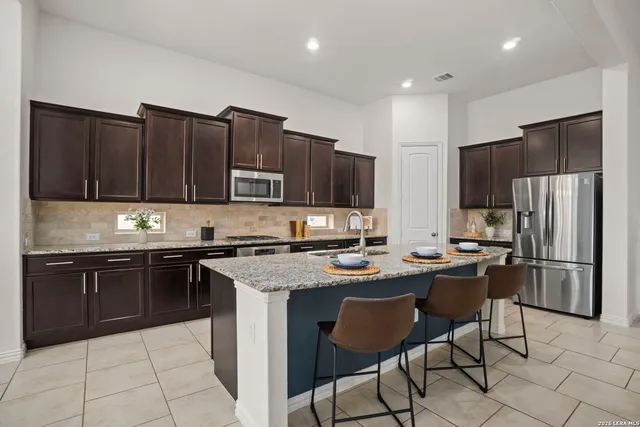 a large kitchen with stainless steel appliances lots of counter top space