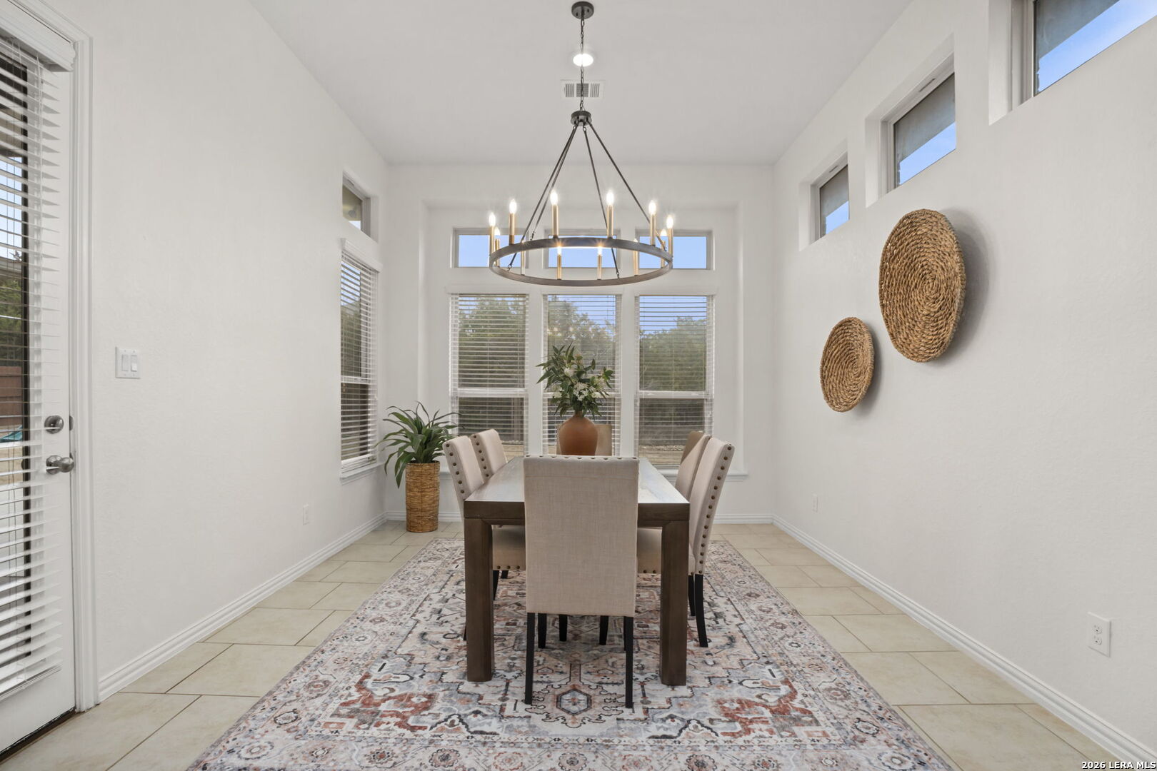 32134 Mirasol Bend Bulverde, TX 78163 - Photo 19 of 44 a dining room with furniture a rug and wooden floor