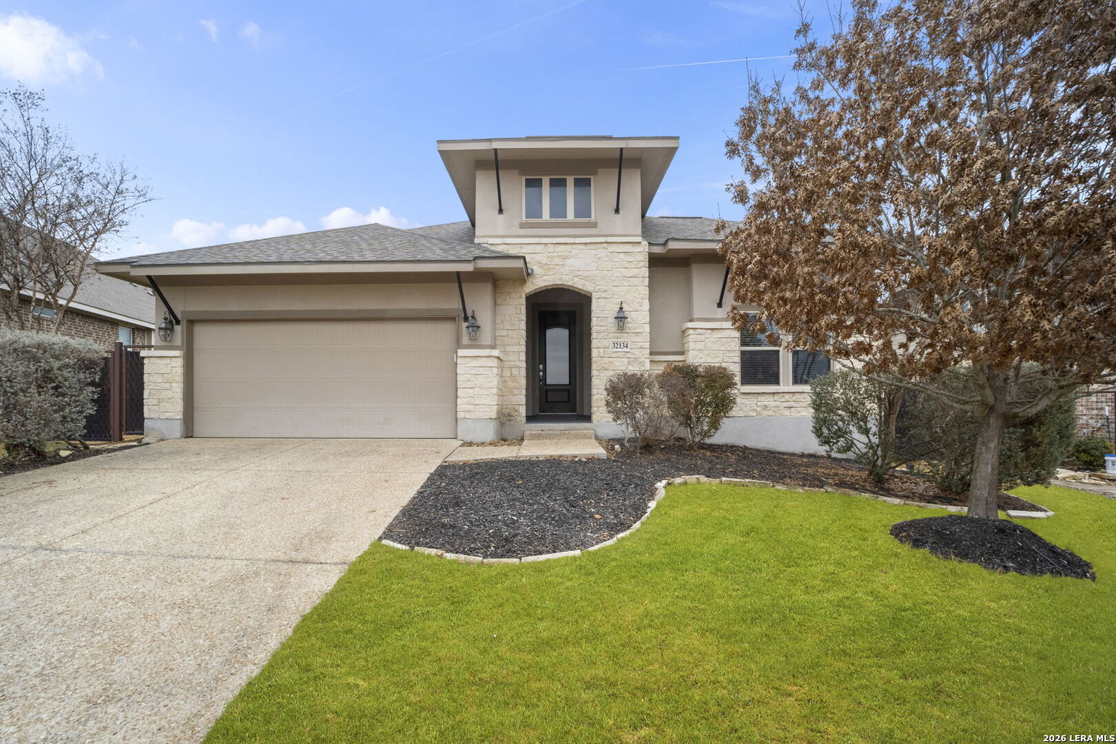 32134 Mirasol Bend Bulverde, TX 78163 - Photo 2 of 44 a front view of a house with a yard and garage