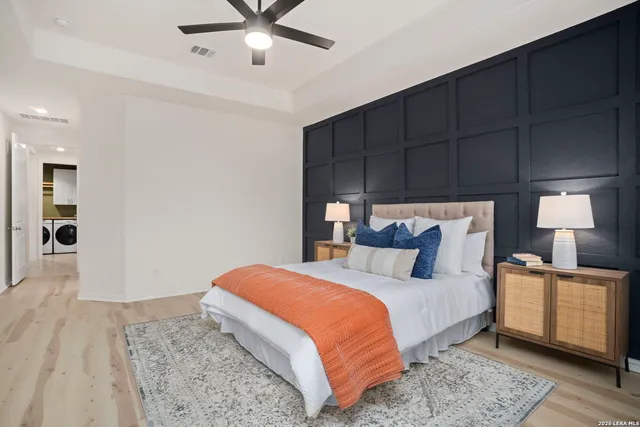 a bedroom with a bed and a large window