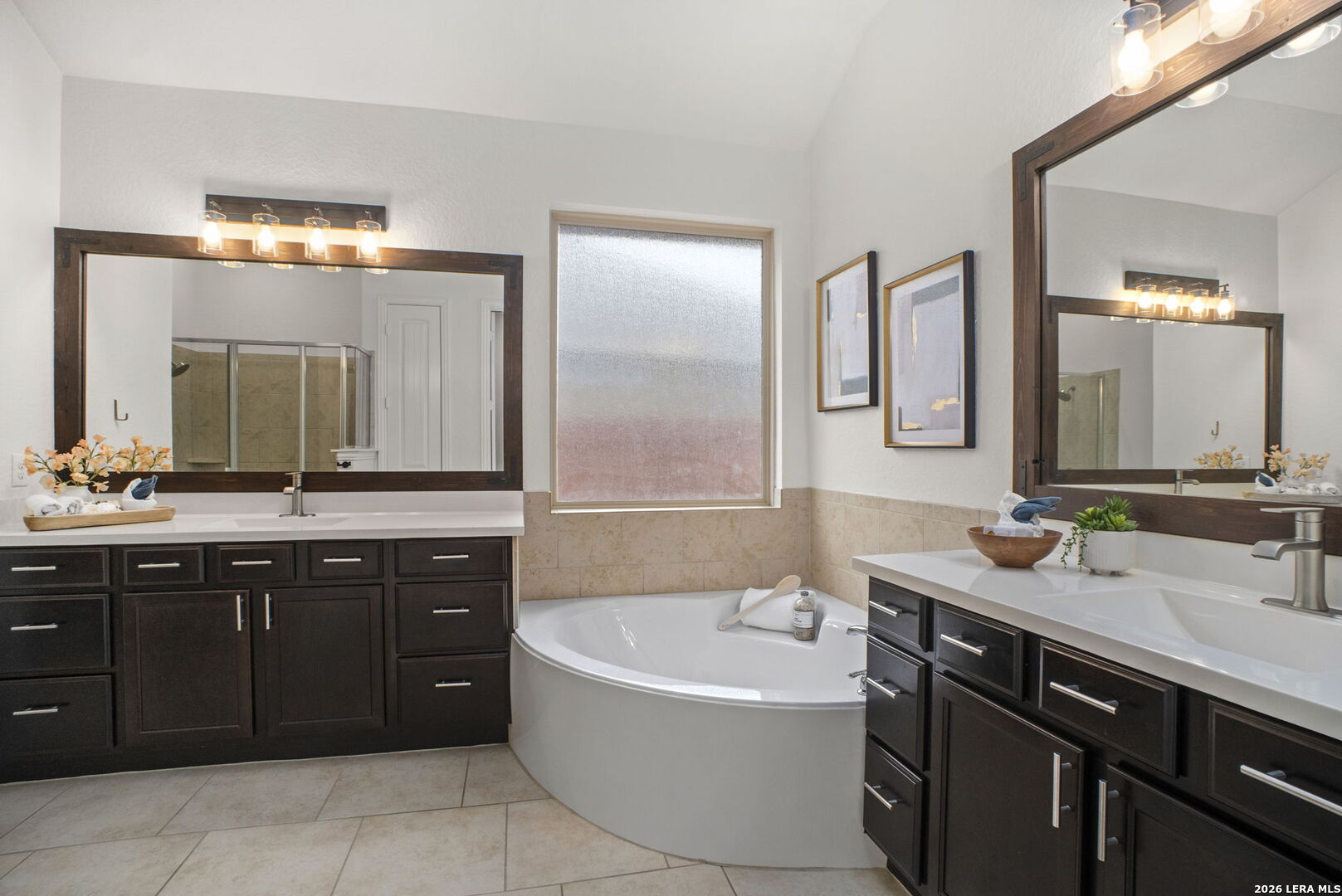 32134 Mirasol Bend Bulverde, TX 78163 - Photo 24 of 44 a bathroom with a tub a double vanity sink and a mirror