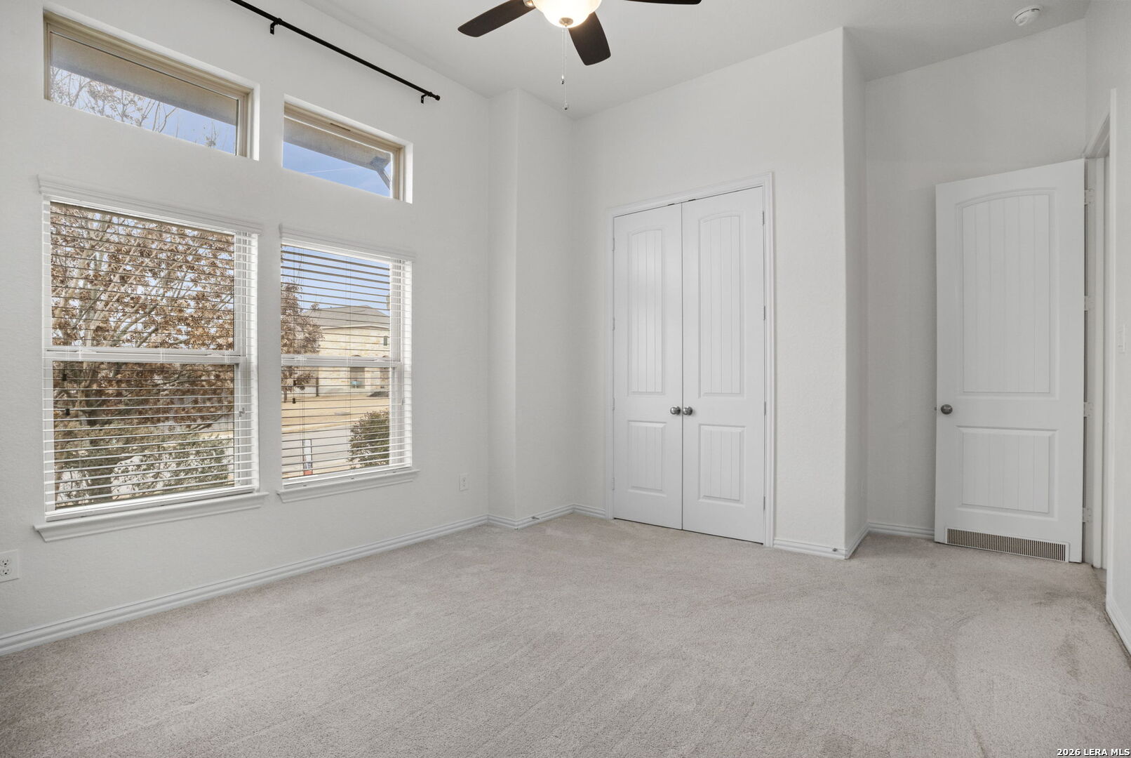 32134 Mirasol Bend Bulverde, TX 78163 - Photo 27 of 44 a view of an empty room with a window and a ceiling fan