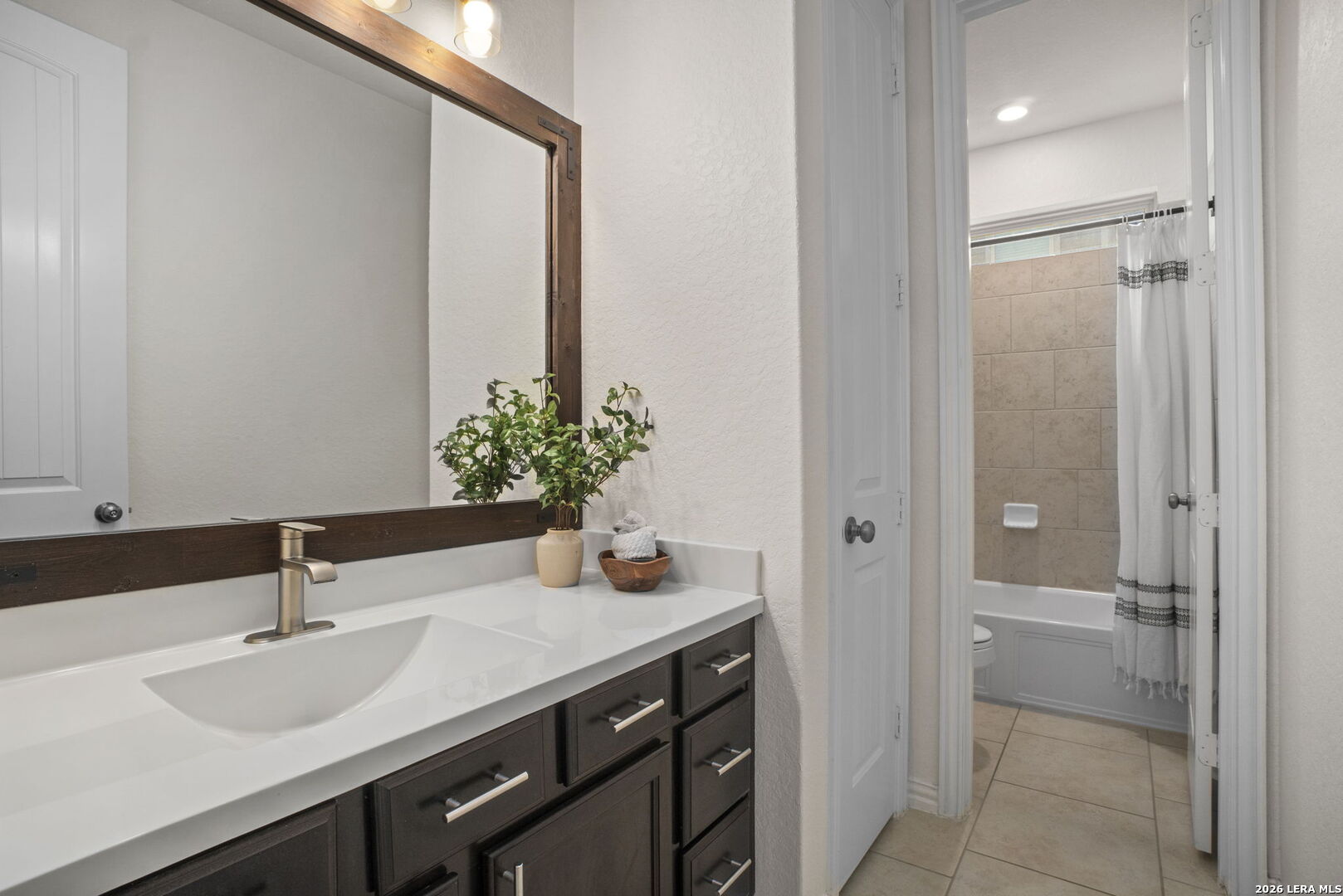 32134 Mirasol Bend Bulverde, TX 78163 - Photo 28 of 44 a bathroom with a granite countertop sink and a mirror