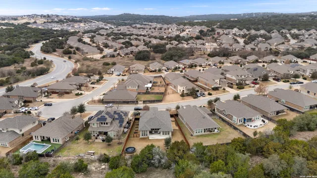 an aerial view of residential houses with outdoor space