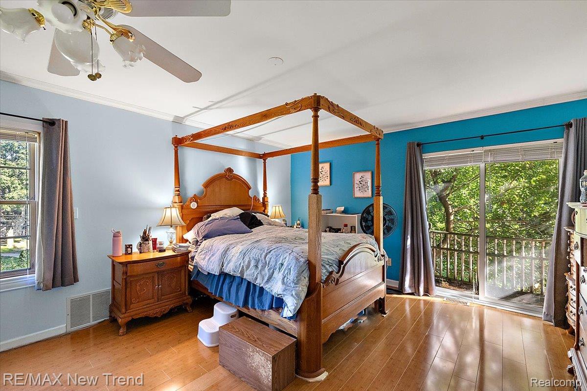 1450 Lenox Road Bloomfield Hills, MI 48304 - Photo 53 of 79 Wood-finish flooring, crown molding, ceiling fan with light fixture, and sliding glass doors to a private balcony