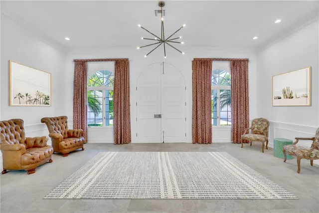 a bedroom with furniture and a large window