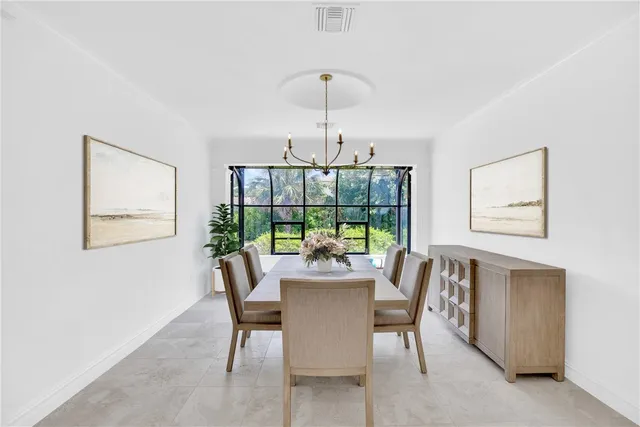 a dining room with furniture a chandelier and wooden floor