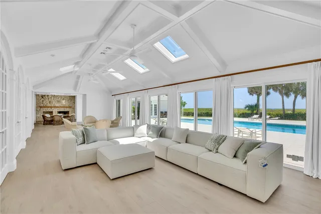 a living room with furniture and large windows