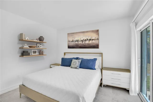 a bedroom with a bed and a night stand