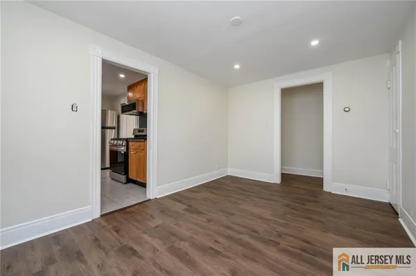 an empty room with wooden floor and closet
