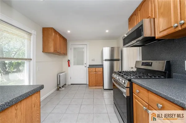 a kitchen with a stove a sink and a refrigerator