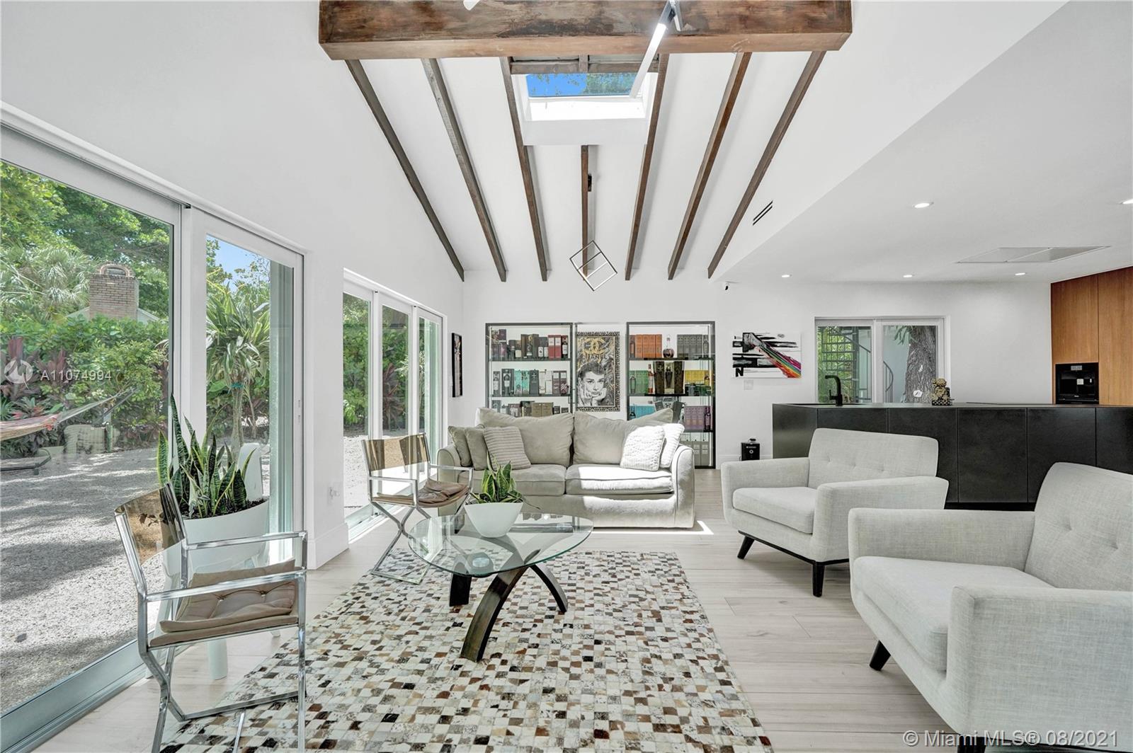 3570 Main Highway Miami, FL 33133 - Photo 11 of 76 a living room with furniture and a large window