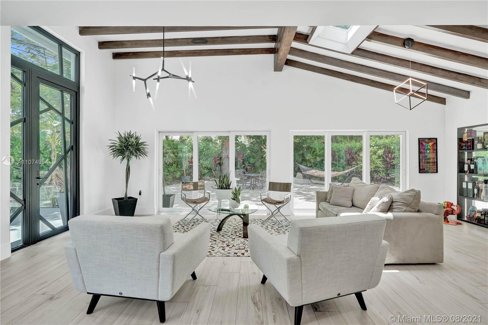 3570 Main Highway Miami, FL 33133 - Photo 12 of 76 a living room with furniture and a large window