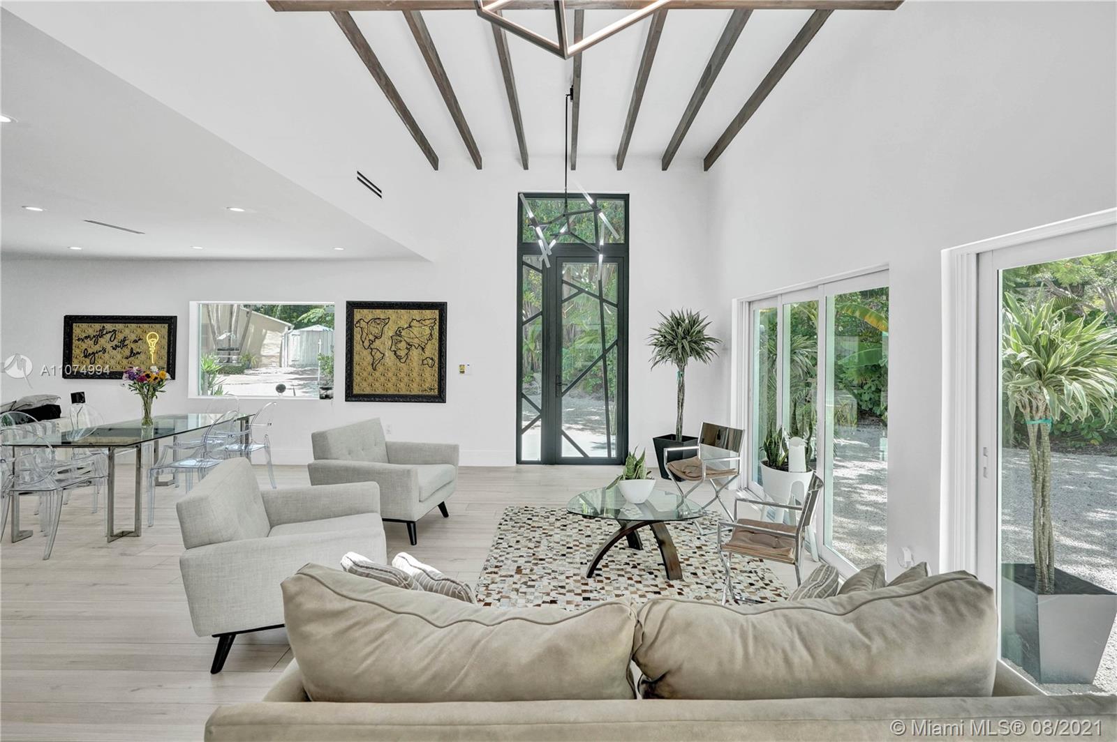 3570 Main Highway Miami, FL 33133 - Photo 14 of 76 a living room with furniture and large windows