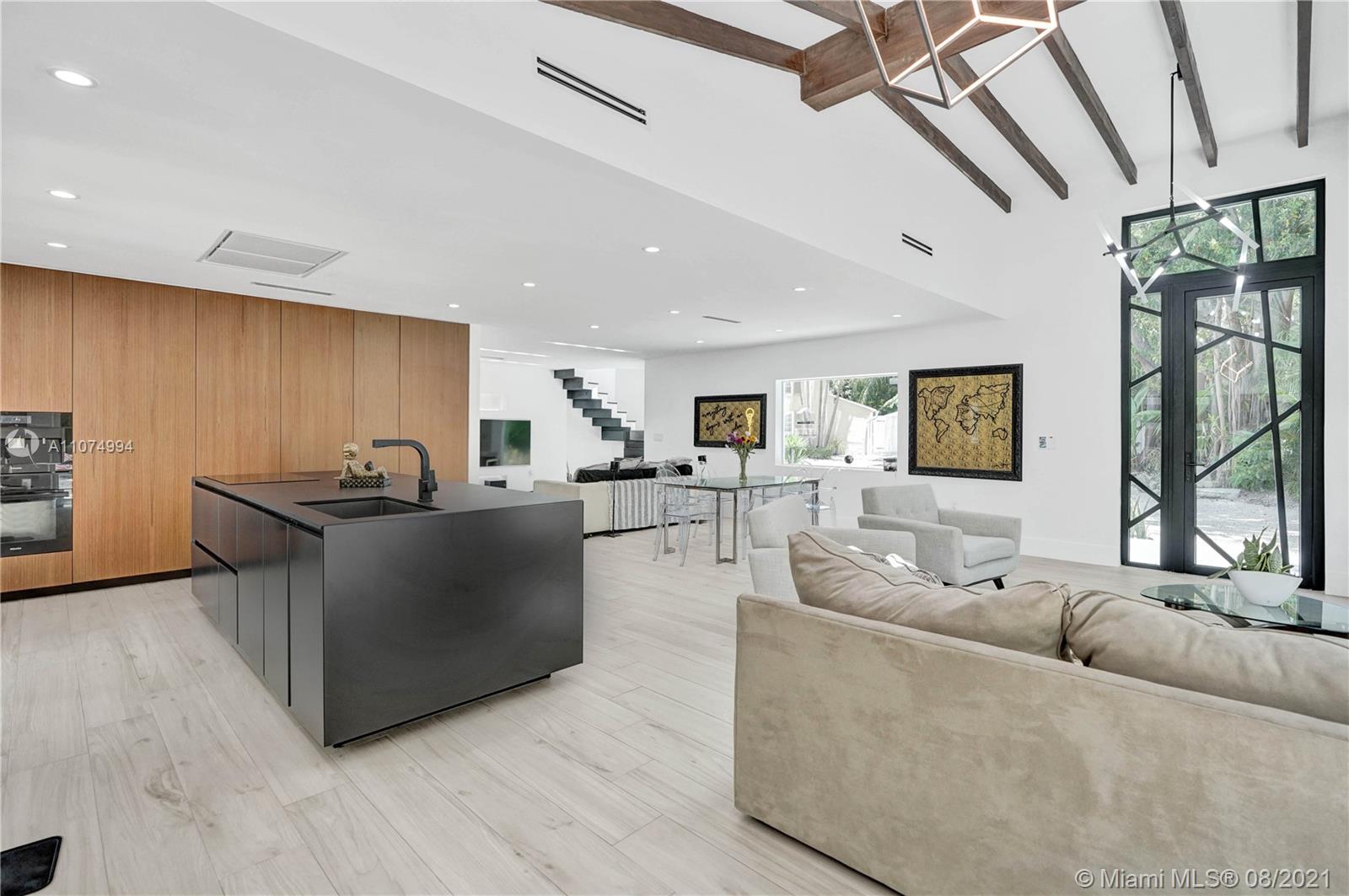 3570 Main Highway Miami, FL 33133 - Photo 15 of 76 a living room with furniture and a flat screen tv