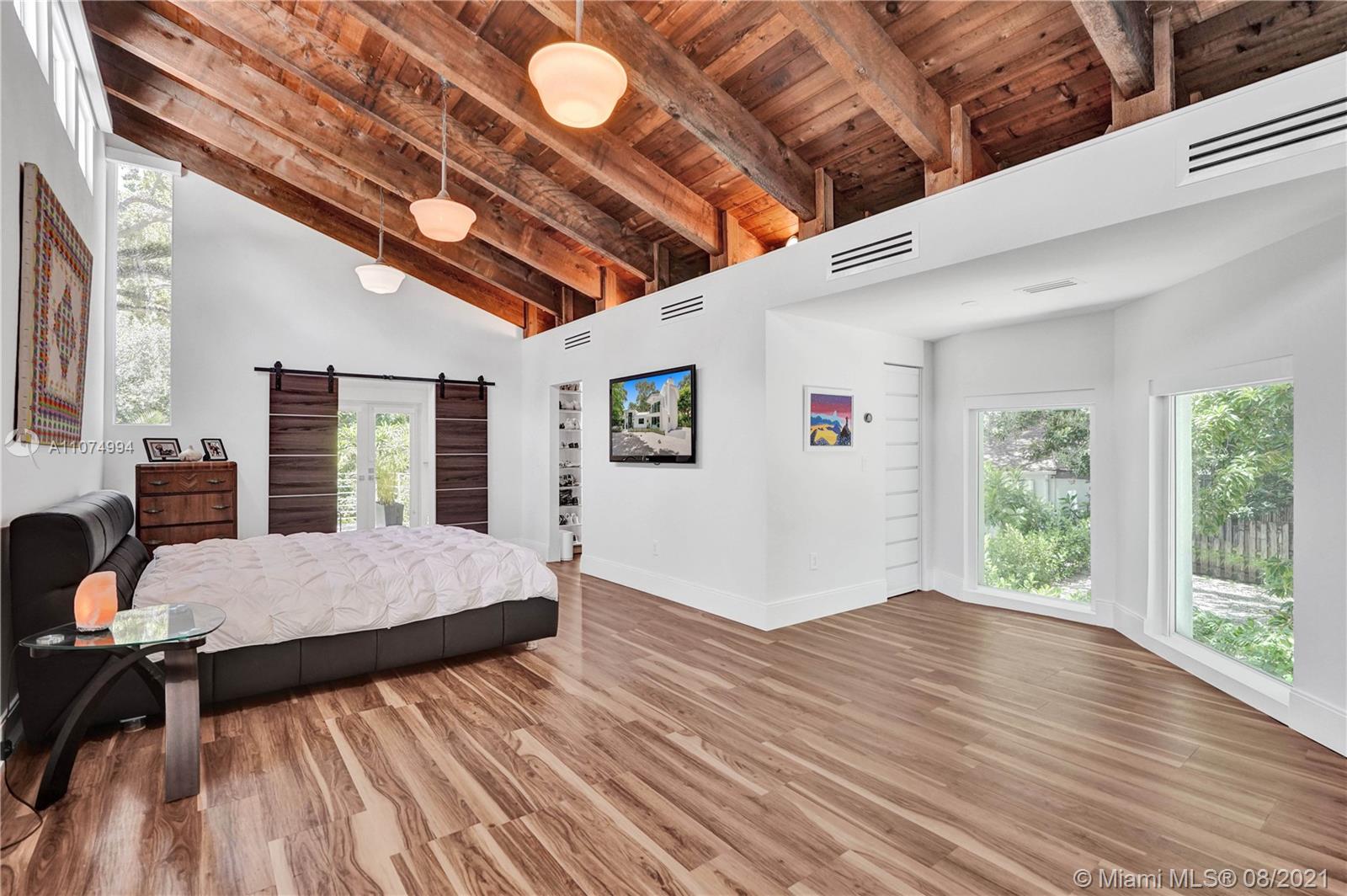 3570 Main Highway Miami, FL 33133 - Photo 30 of 76 a workspace with furniture large windows and wooden floor