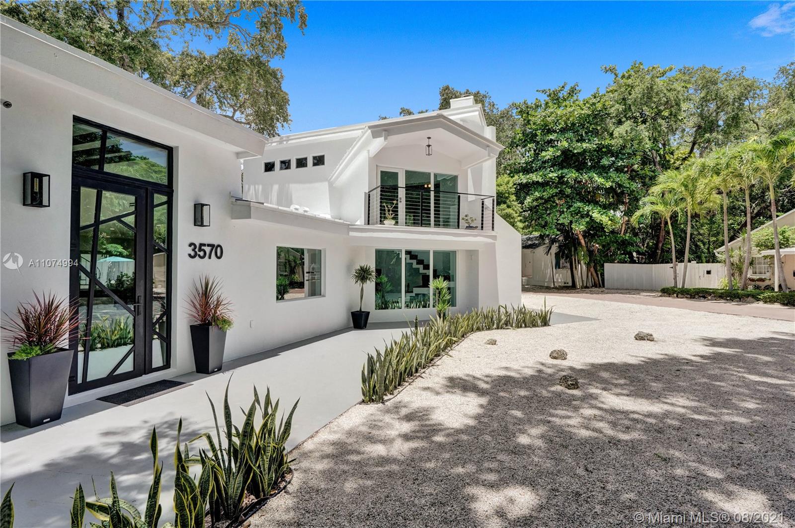 3570 Main Highway Miami, FL 33133 - Photo 4 of 76 a front view of a house with a yard