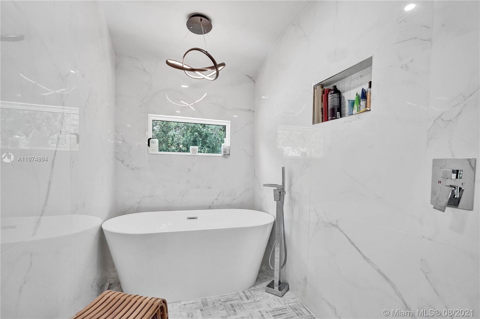 3570 Main Highway Miami, FL 33133 - Photo 37 of 76 a bathroom with a bathtub and shower