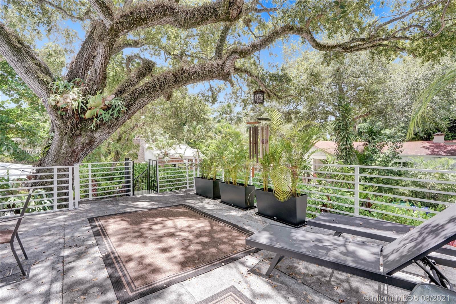 3570 Main Highway Miami, FL 33133 - Photo 40 of 76 a view of a yard with plants and trees