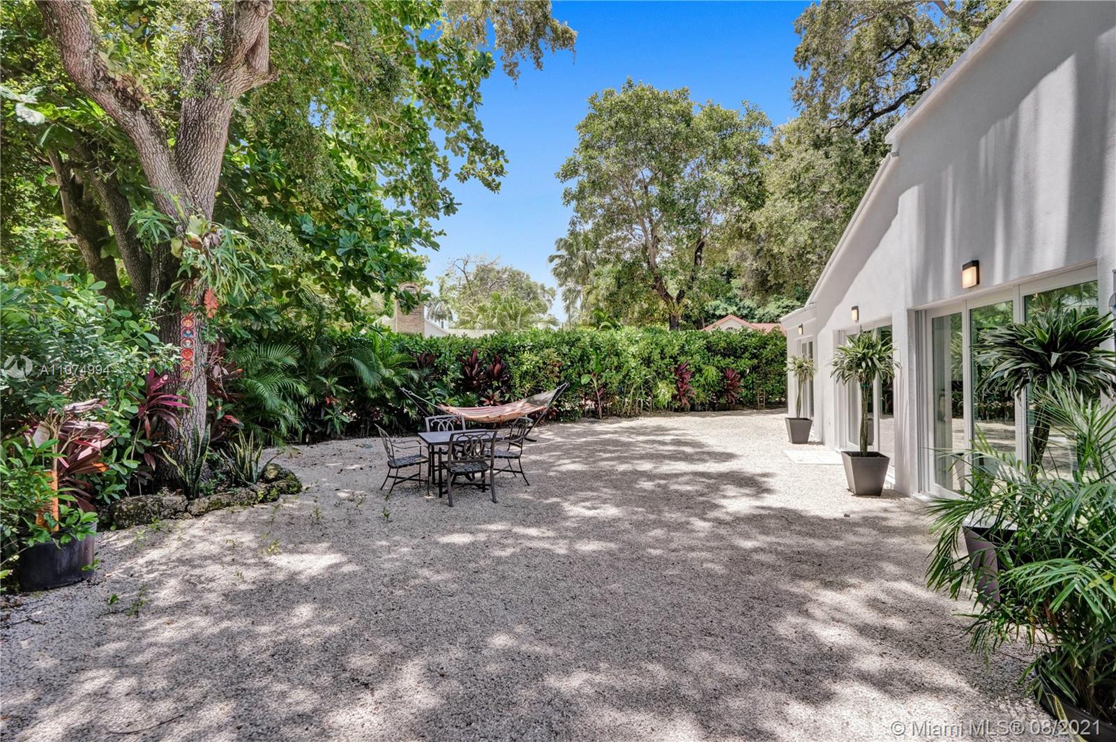 3570 Main Highway Miami, FL 33133 - Photo 5 of 76 a view of a backyard with sitting area and garden