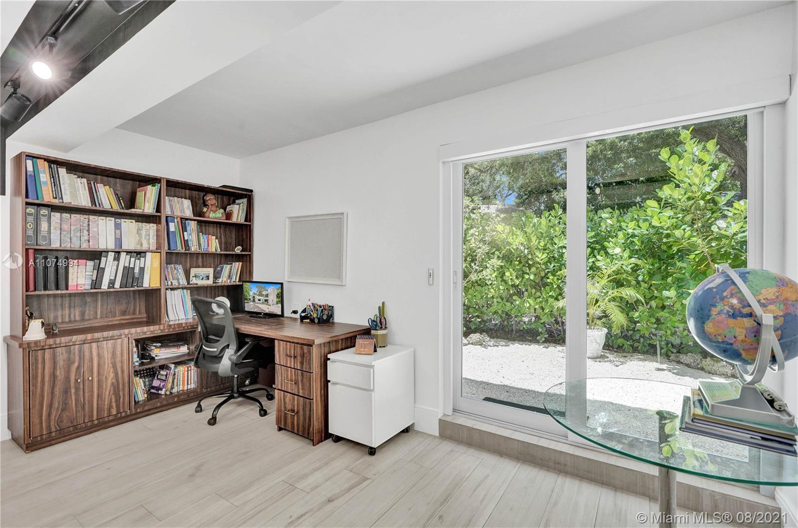 3570 Main Highway Miami, FL 33133 - Photo 44 of 76 a view of a workspace with furniture and a window