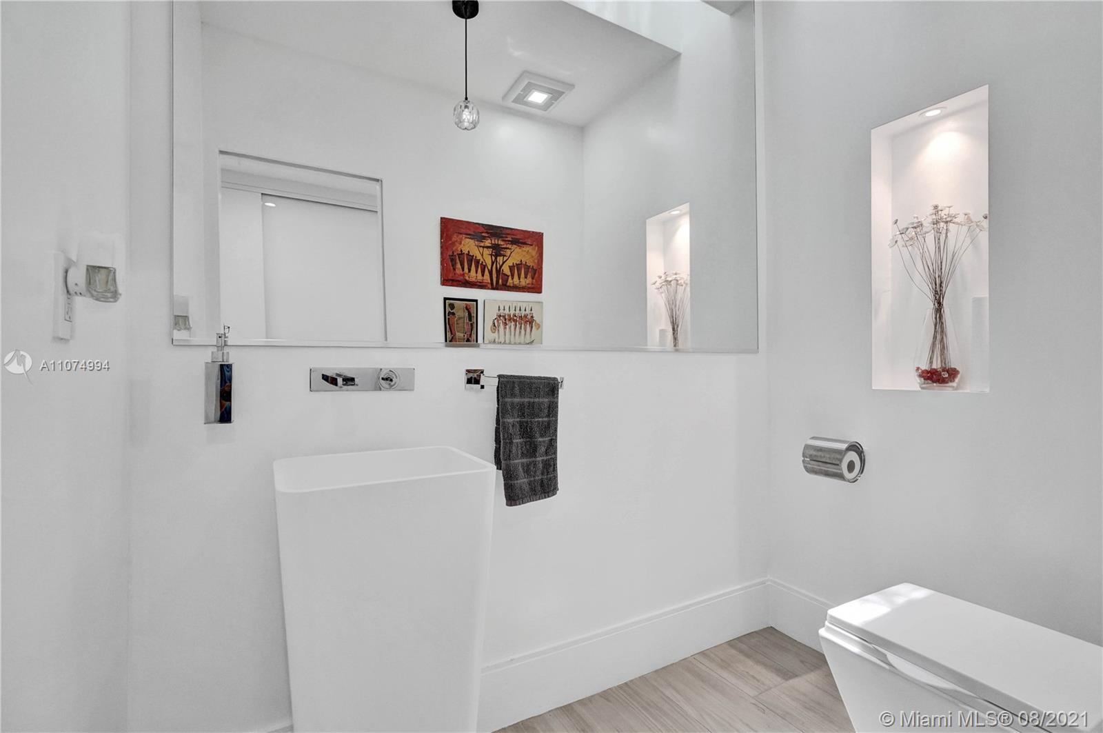 3570 Main Highway Miami, FL 33133 - Photo 45 of 76 a bathroom with a shower and a toilet