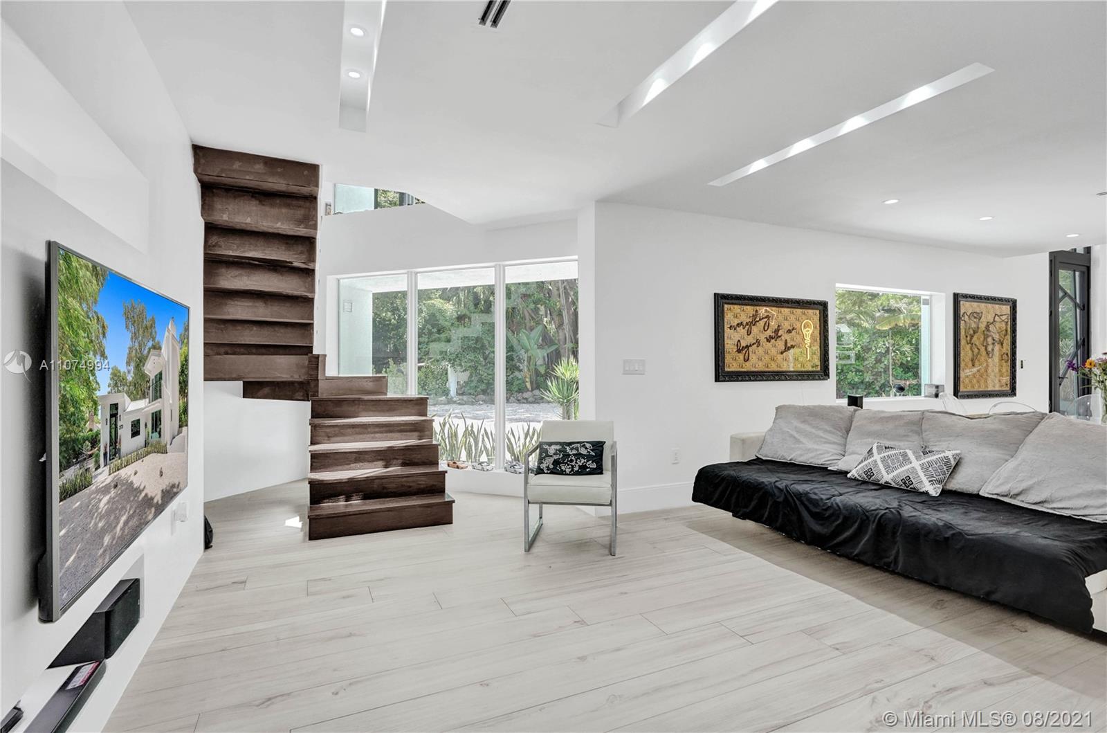 3570 Main Highway Miami, FL 33133 - Photo 48 of 76 a living room with furniture and a flat screen tv