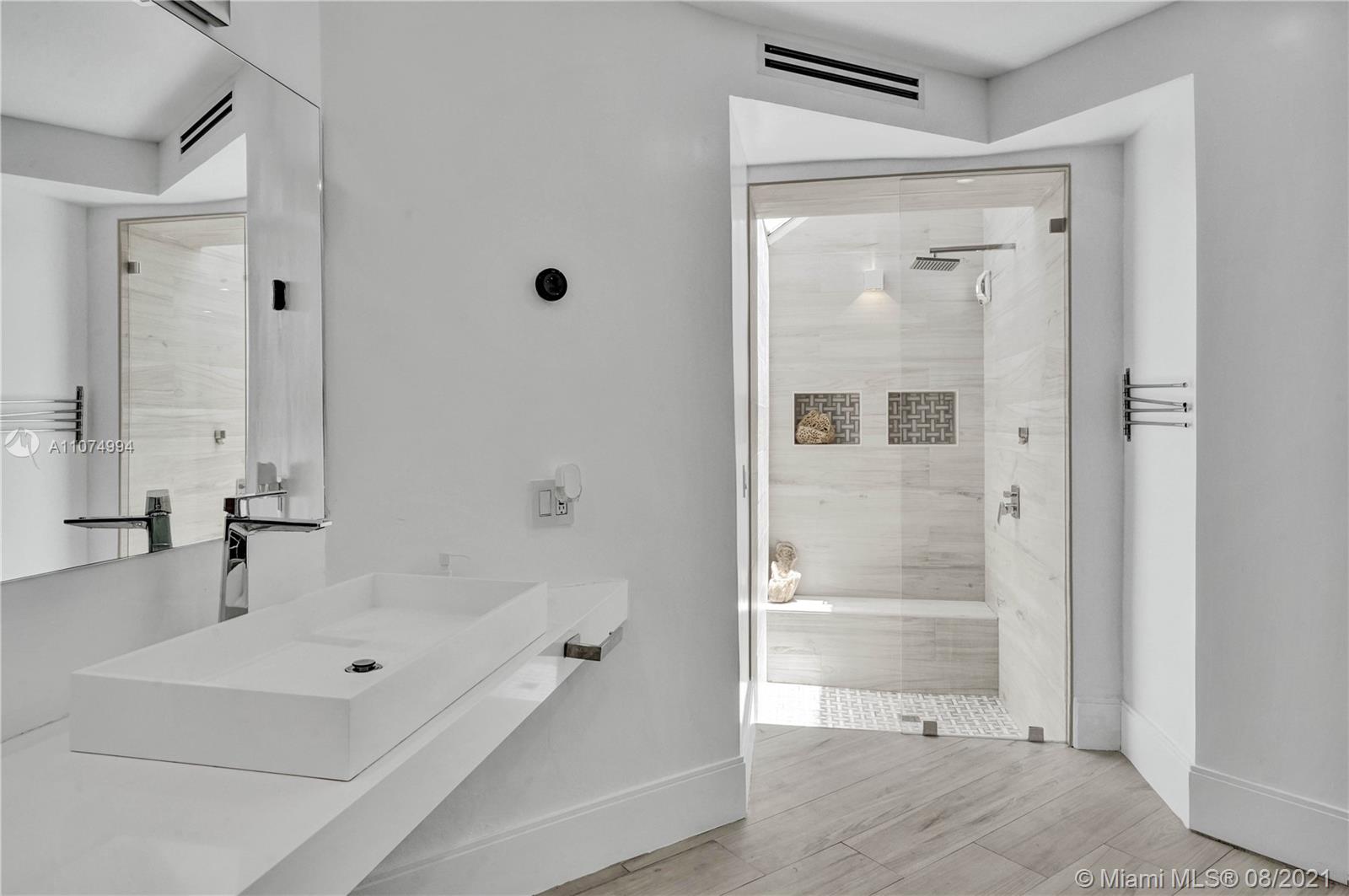 3570 Main Highway Miami, FL 33133 - Photo 54 of 76 a bathroom with a bathtub and a shower