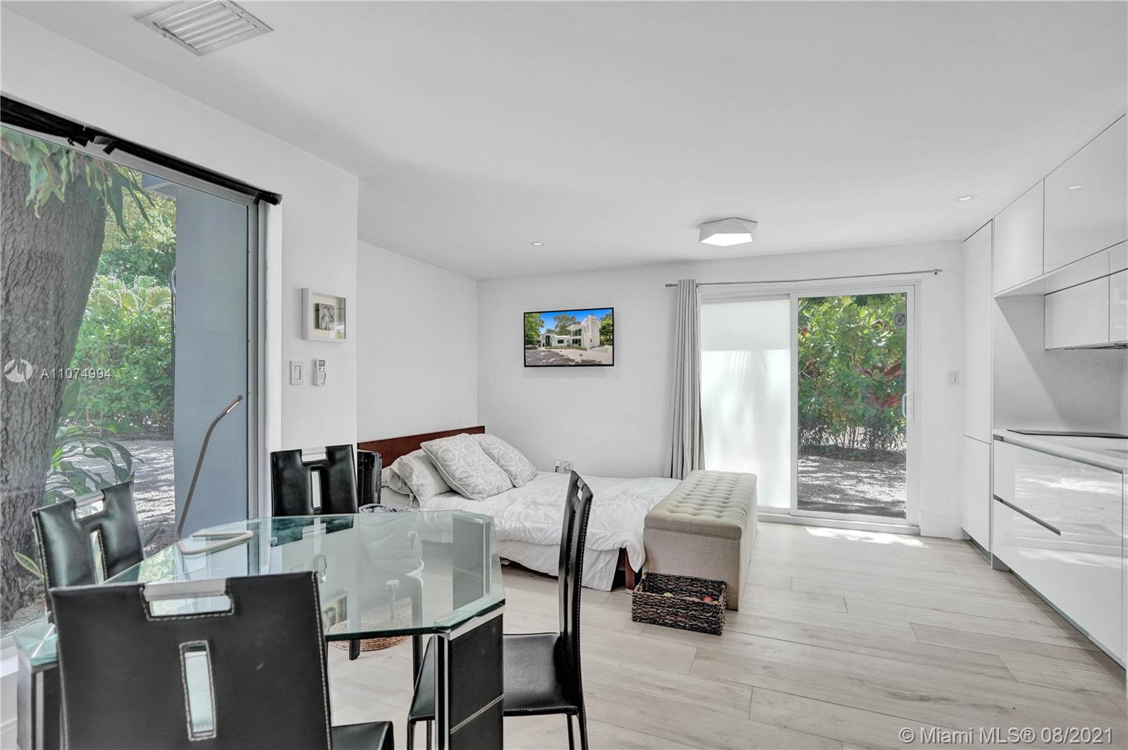 3570 Main Highway Miami, FL 33133 - Photo 59 of 76 a living room with furniture and a large window