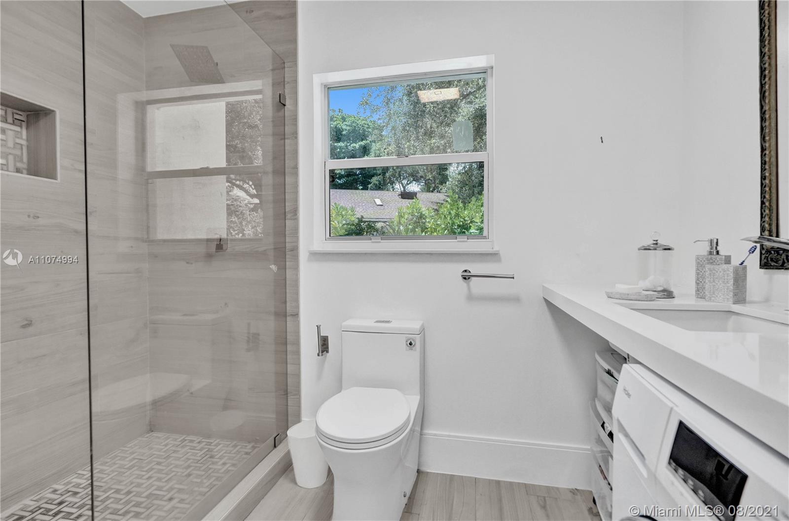 3570 Main Highway Miami, FL 33133 - Photo 60 of 76 a bathroom with a sink toilet and shower