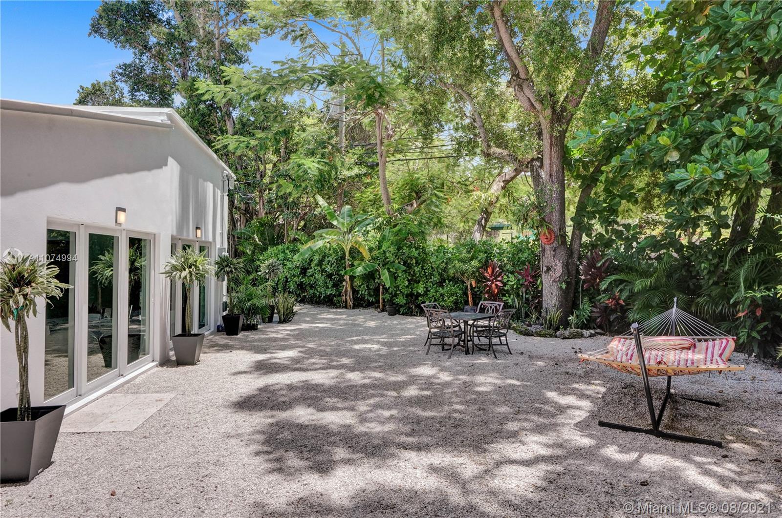 3570 Main Highway Miami, FL 33133 - Photo 7 of 76 a view of a patio with table and chairs and potted plants