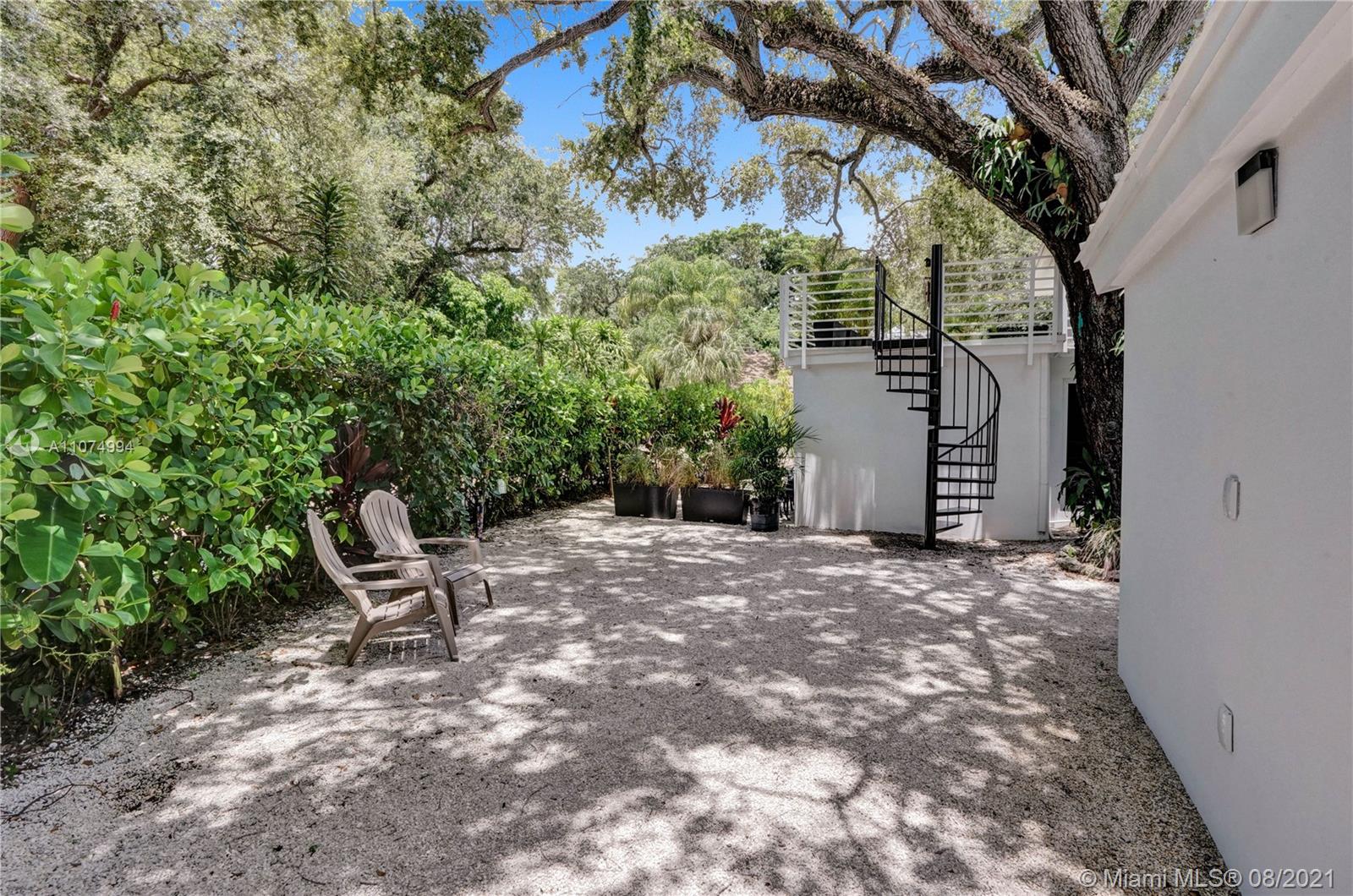 3570 Main Highway Miami, FL 33133 - Photo 8 of 76 a view of outdoor space with deck and tree