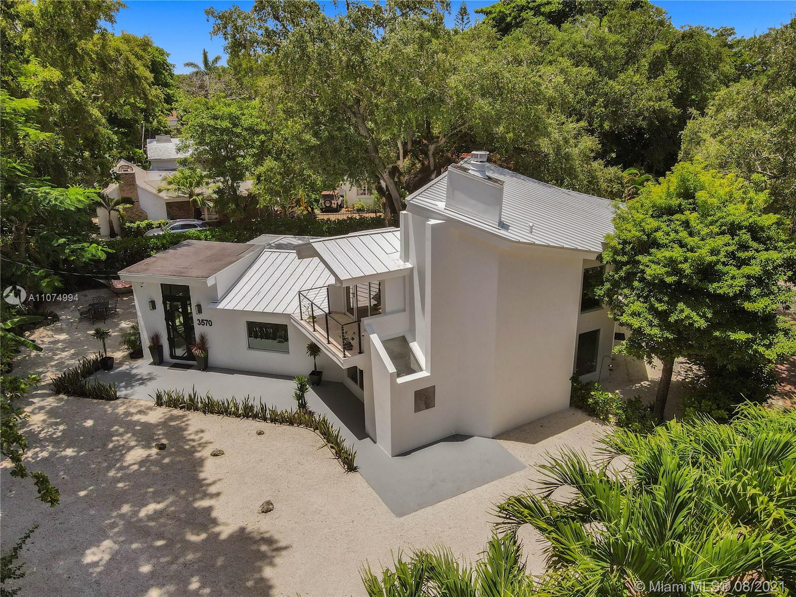 3570 Main Highway Miami, FL 33133 - Photo 76 of 76 an aerial view of a house with a yard
