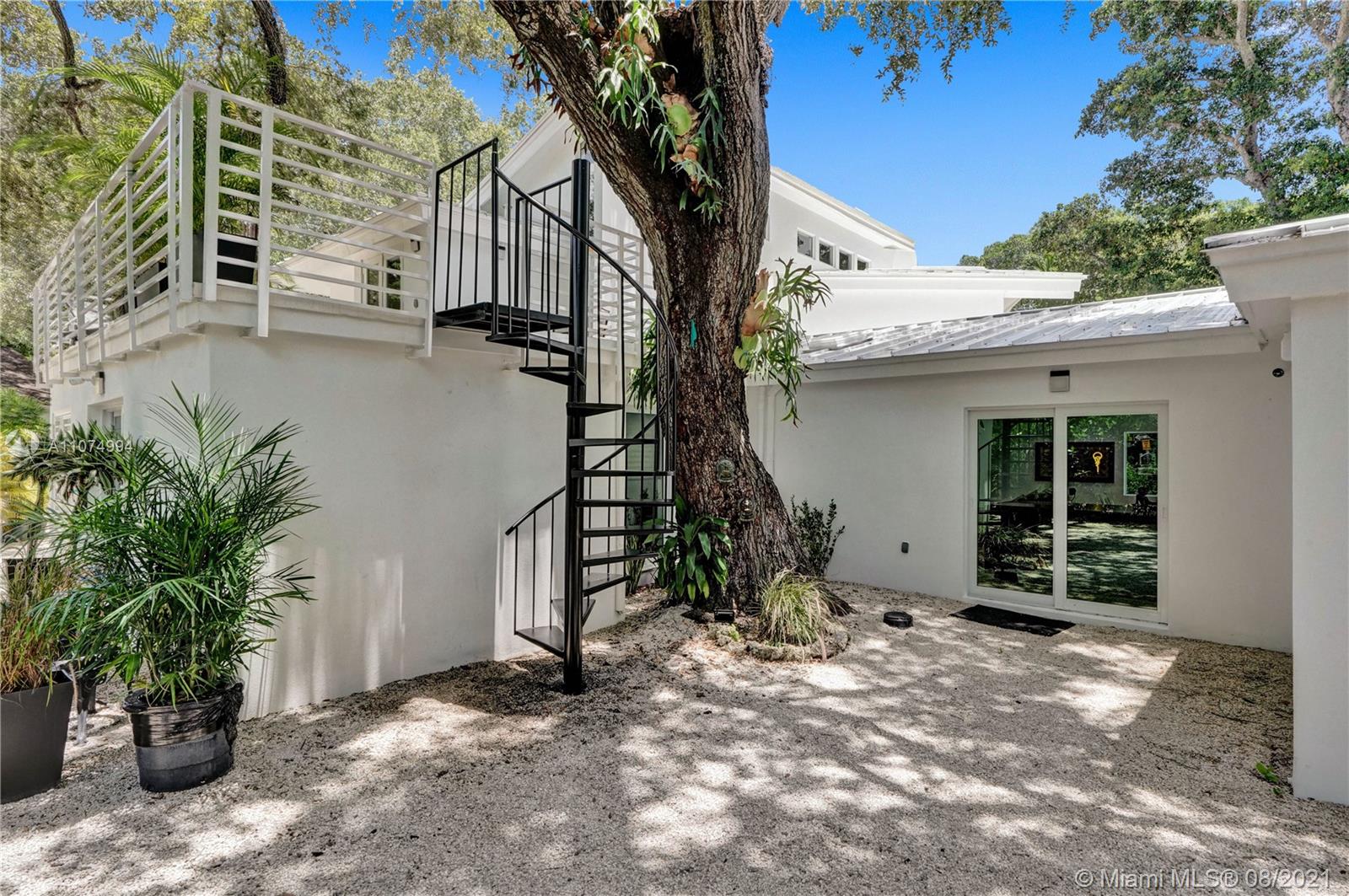 3570 Main Highway Miami, FL 33133 - Photo 9 of 76 a front view of a house with a yard
