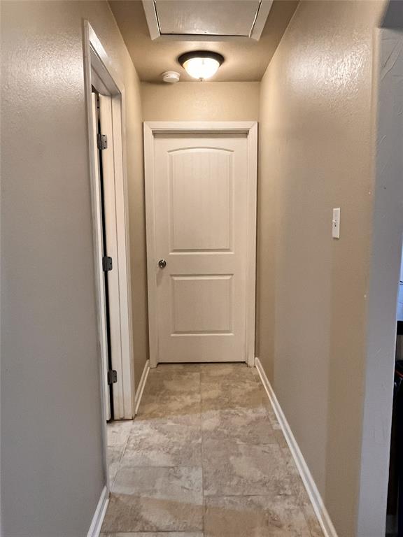 420 Sessums Road Springtown, TX 76082 - Photo 25 of 40 Hallway featuring baseboards