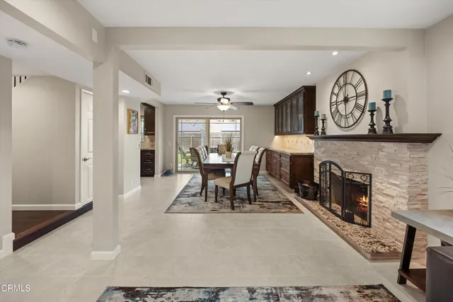 a living room with furniture a clock and a large window