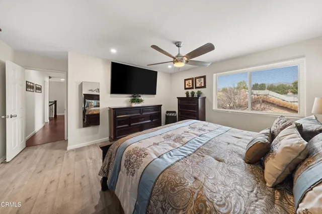 a bedroom with a large bed and a flat screen tv