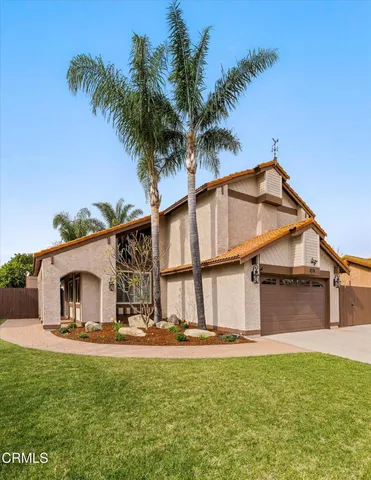 a backyard of a house with table and chairs